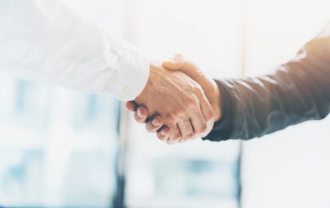 Business partnership meeting. Picture businessmans handshake. Successful businessmen handshaking after good deal. Horizontal, blurred